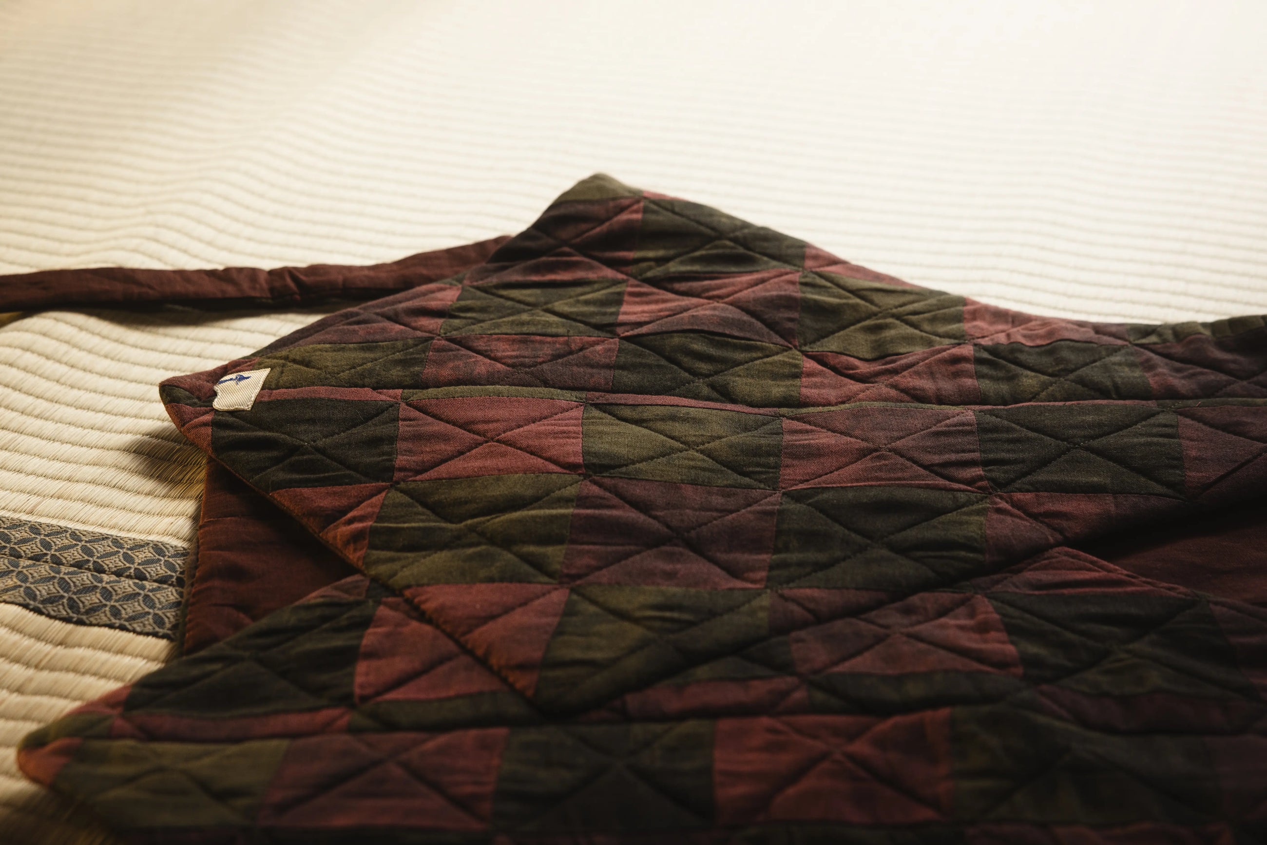 Quilted fabric with geometric pattern on a textured surface