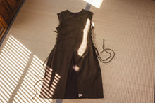 Brown dress with fringes on a textured surface