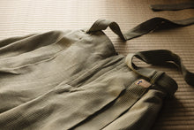 Green bag with straps on a textured surface