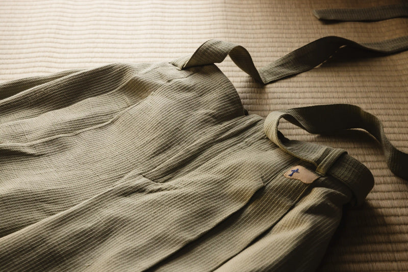 Green bag with straps on a textured surface