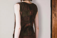 Brown sleeveless top worn by a person on a plain background